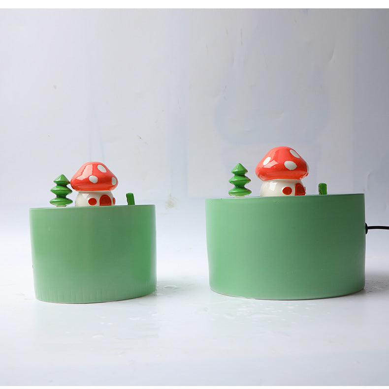 Green automatic pet water dispenser with mushroom and tree decorations for animal comfort