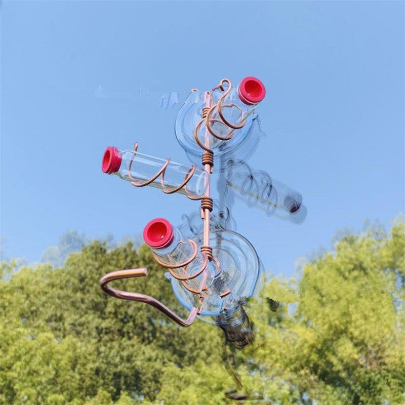 Unique metal and glass Garden Bird Feeder with red accents mounted outdoors against a clear blue sky