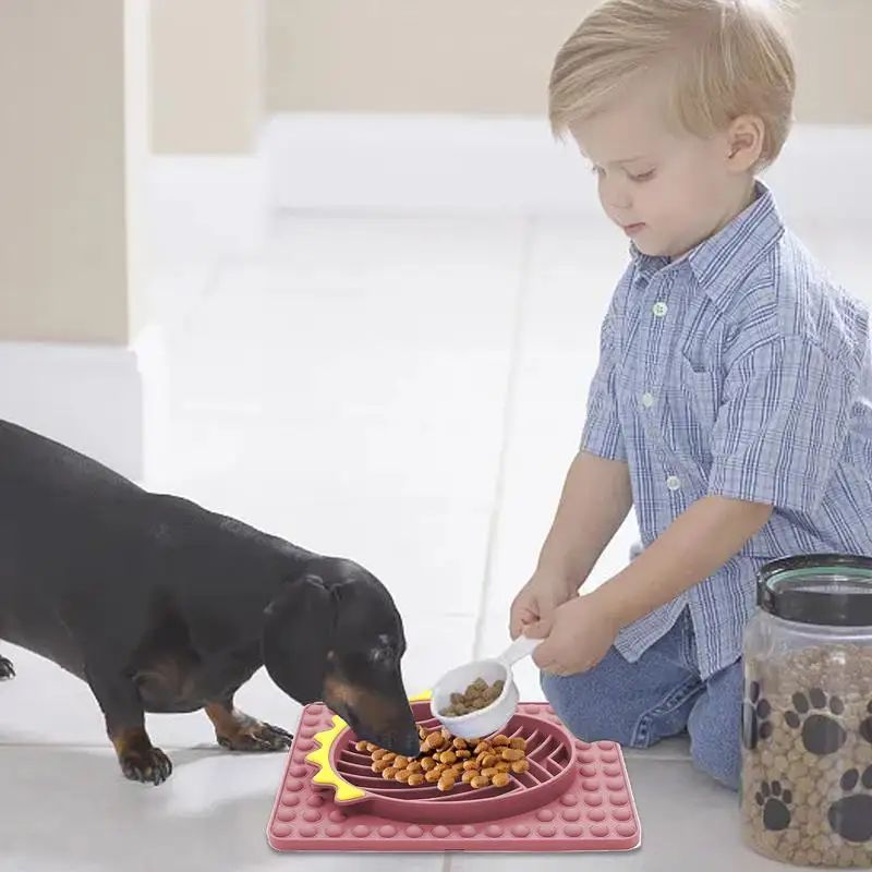 Child feeding dachshund with Slow Feeder Dog Bowls by Furfamilyclub for pet eating comfort