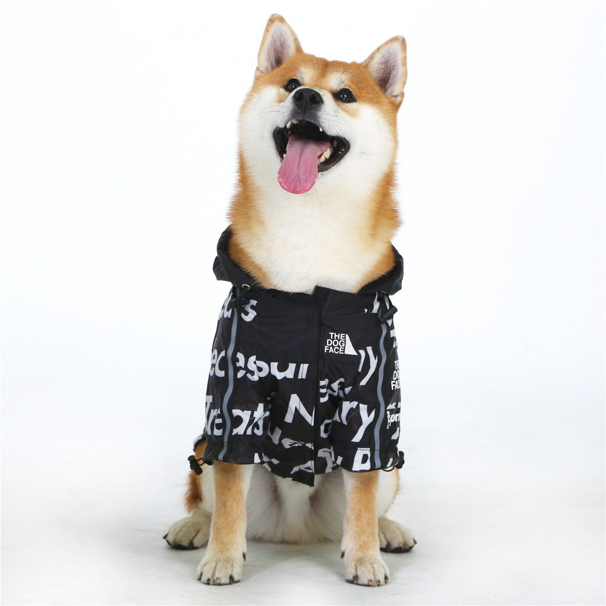 Happy Shiba Inu wearing Furfamilyclub black hooded windproof dog jacket with white text print sitting