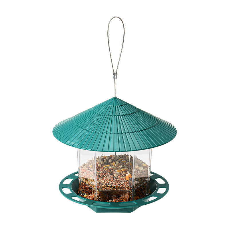 Transparent Bird Feeder with green roof and circular seed tray filled with mixed bird seeds