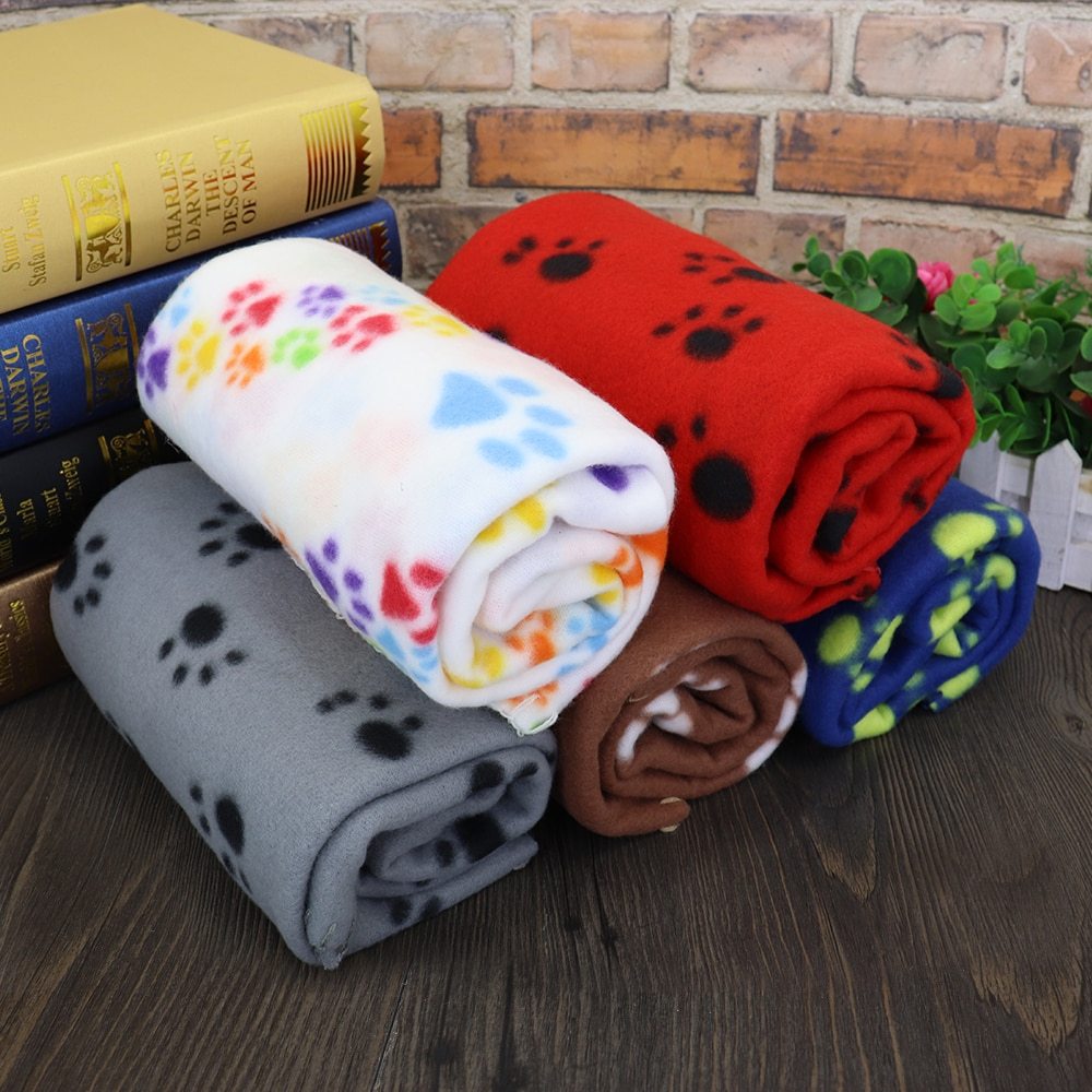 Colorful Christmas pet blanket set featuring paw print designs for your furry friends' comfort