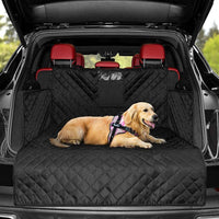 Golden retriever lying on a durable travel mat for dogs in the back of a black SUV with red seats