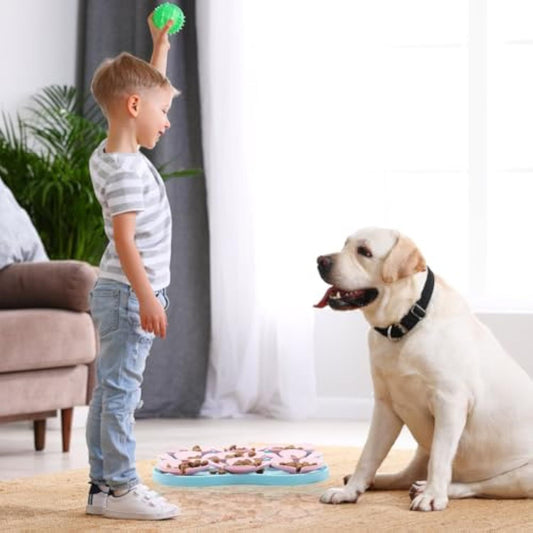 Child playing with a Labrador near the Eating Pet Calming Mat with treats on a carpet indoors
