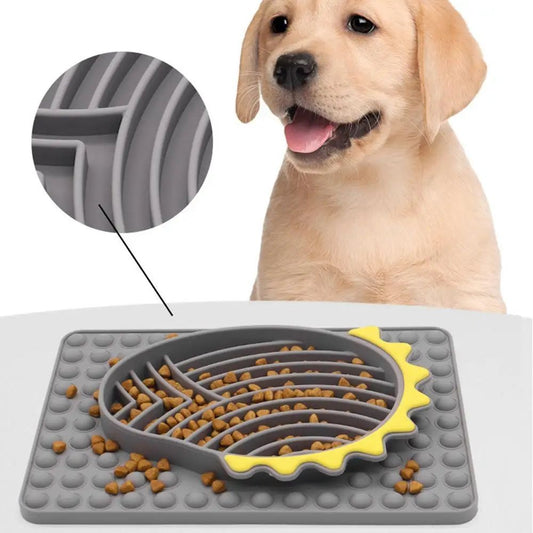 Furfamilyclub Slow Feeder Dog Bowls in gray and yellow on a mat with a happy Labrador puppy